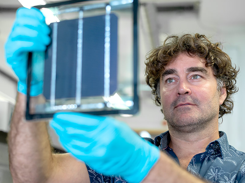 Professor Henry Snaith holds up a perovskite solar cell