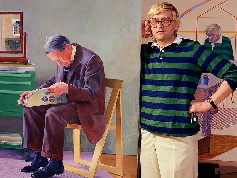 David Hockney stands next to one of his own paintings, which depicts a seated man reading a newspaper. A self-portrait painting of the artist appears behind him