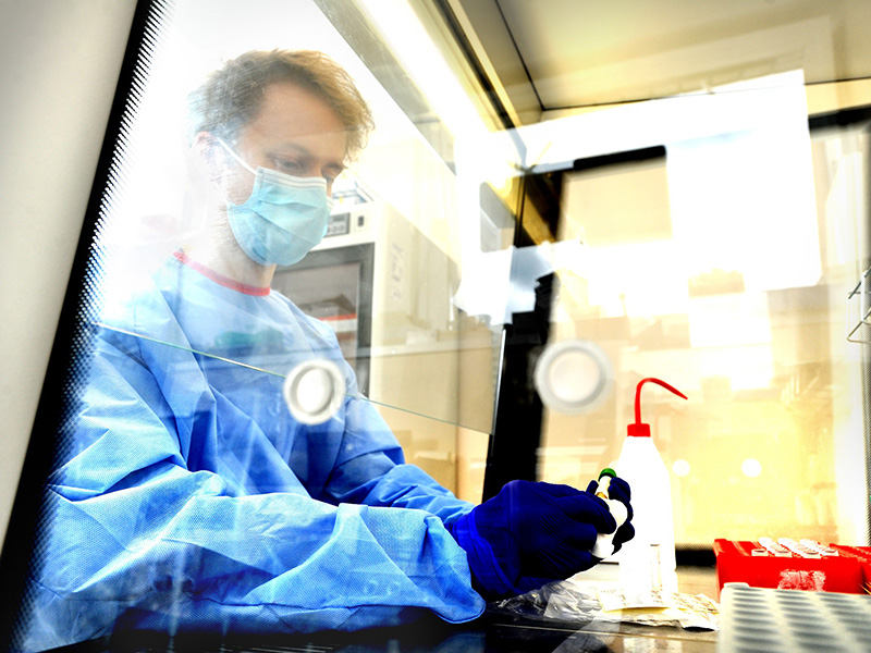 Professor in lab wearing blue suit and mask A multidisciplinary team of scientists are continuously assessing new COVID-19 variants Credit: Jon Lewis for Oxford Hospitals Charity