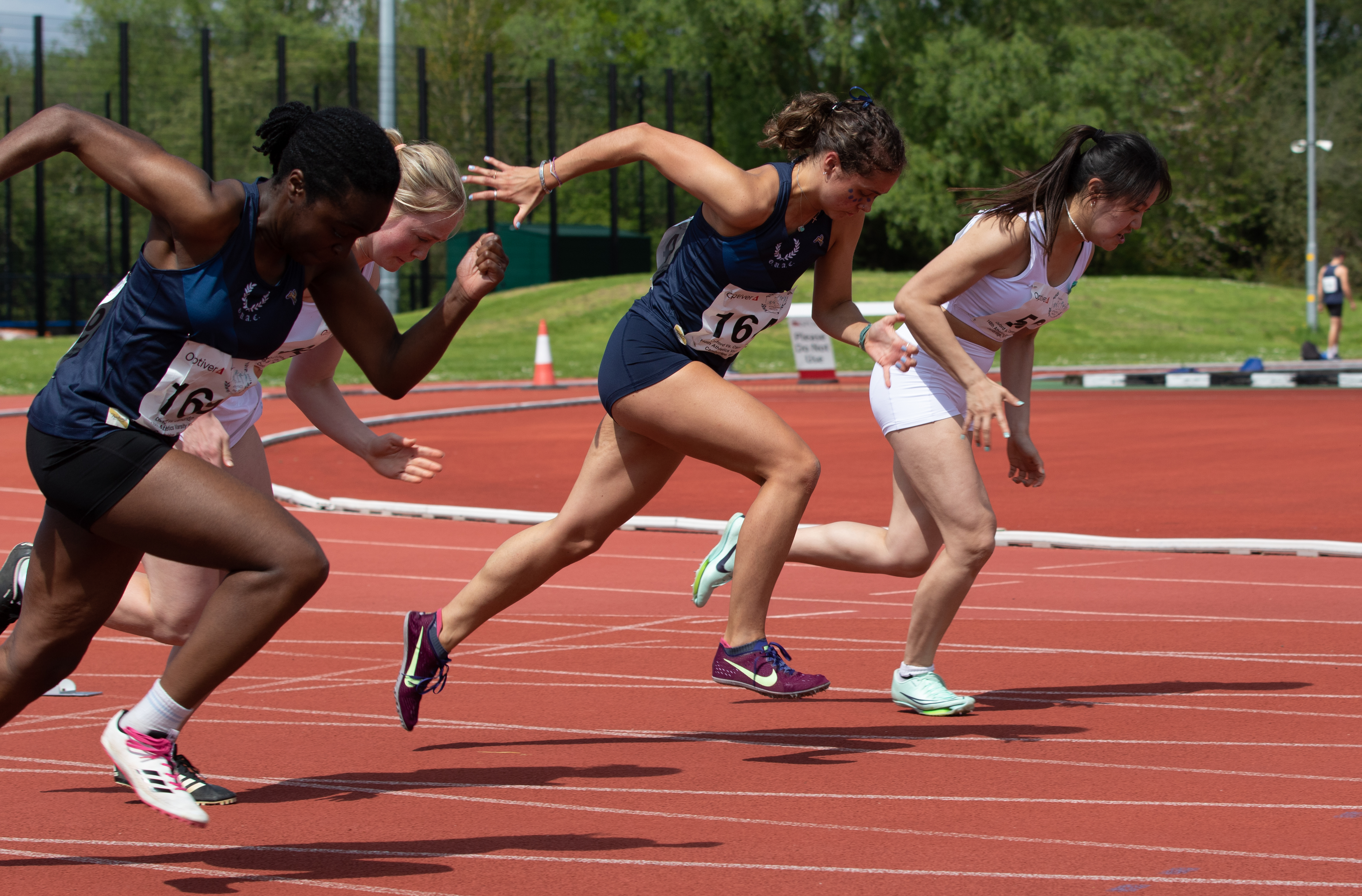 Oxford University athletes running on the track
