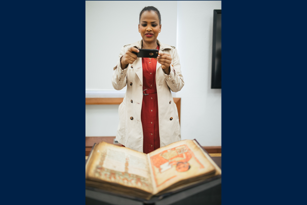 Visitor bringing one of the sacred Ge’ez manuscripts of Ethiopia and Eritrea to life on her phone