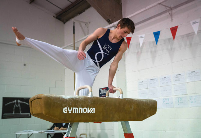 Gymnast training on pommel horse