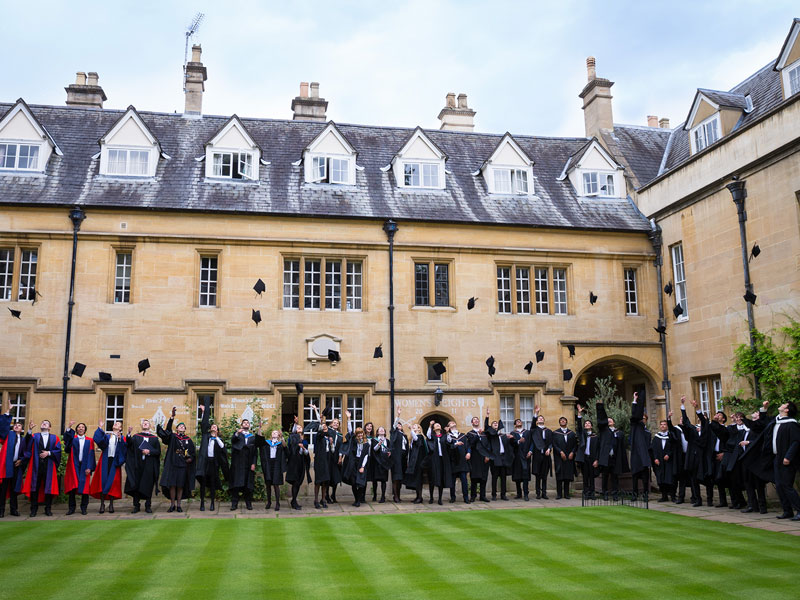 Students celebrating their graduation at Lincoln College. Photo by Fisher Studios.