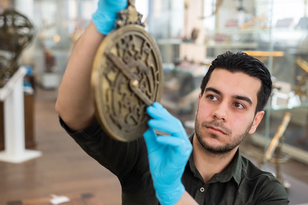 Researcher with astrolabe