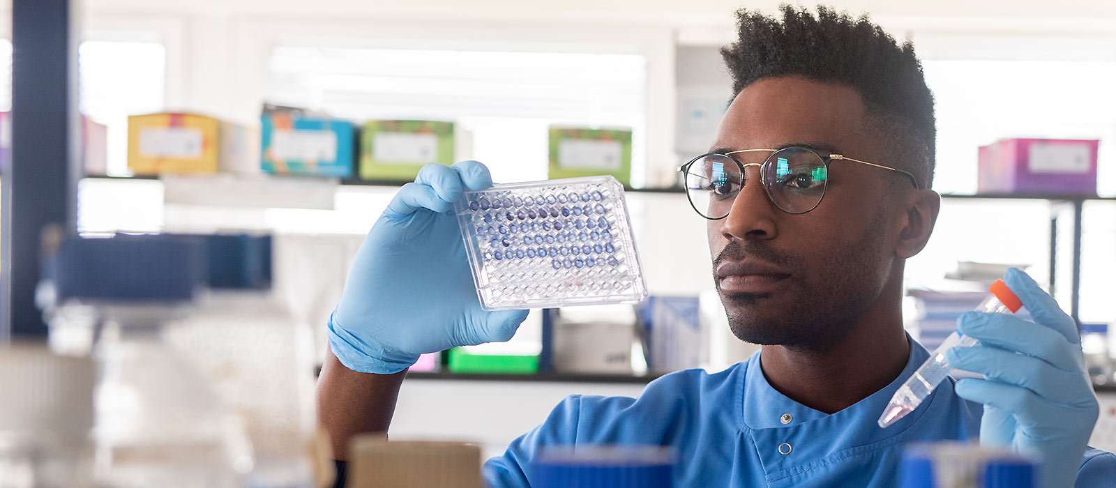 A COVID-19 vaccine researcher using scientific equipment in an Oxford University laboratory