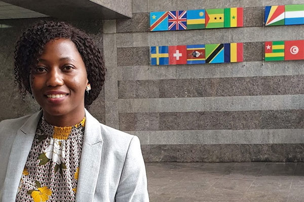 Swarovski Scholar graduate Claire Nakabugo standing in the reception of the African Development Bank.