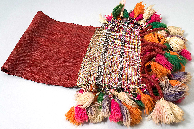 A madder, white, black and yellow Omani camel saddle cloth from the Pitt Rivers Museum’s collections
