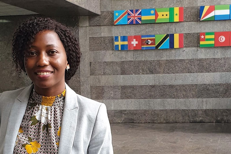 Swarovski Scholar graduate Claire Nakabugo standing in the reception of the African Development Bank