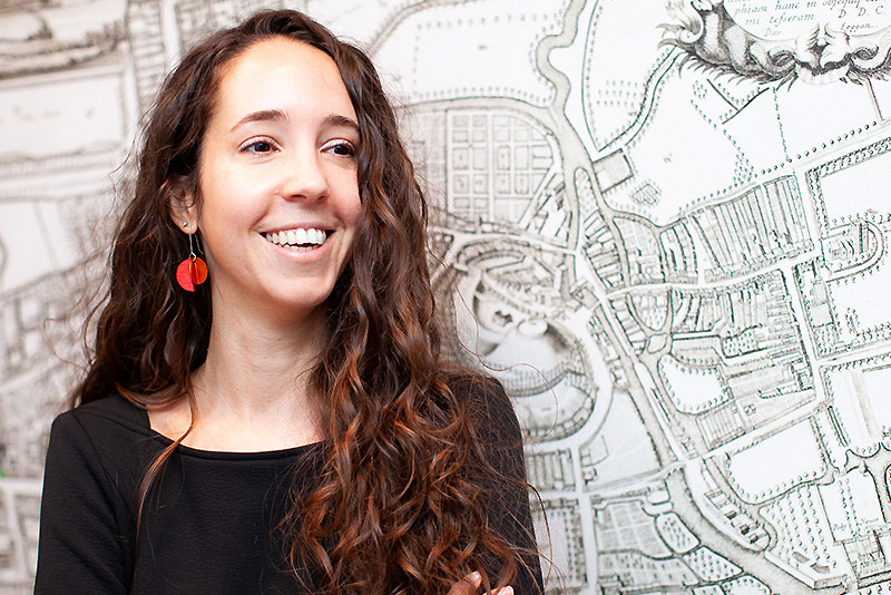 Dr Federica Gigante standing in front of a large historic map