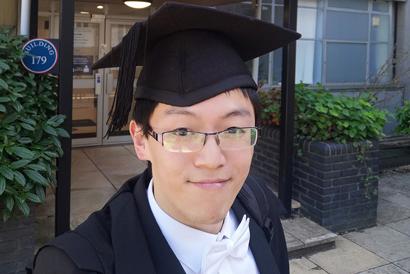 DPhil scholarship student Kai Zhang dressed in sub fusc after having completed his viva in the Department of Materials