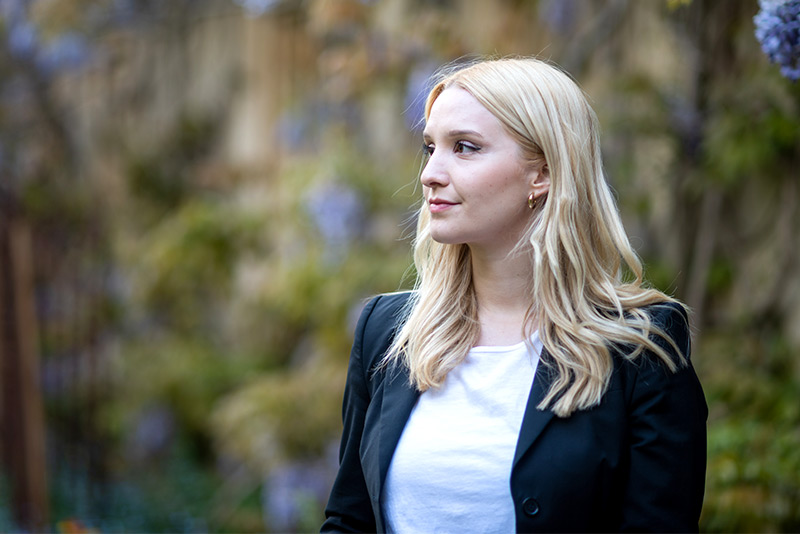 Sophie Forst stands in the gardens of Balliol College