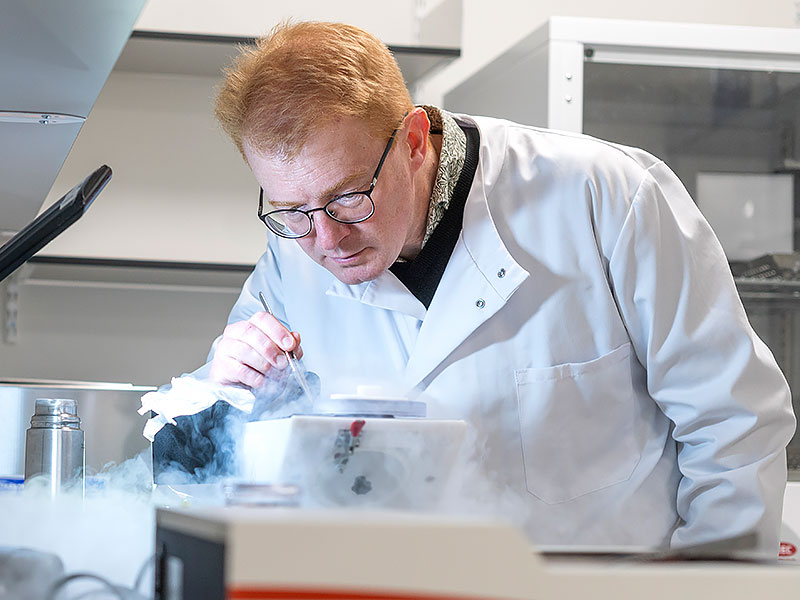 Professor Matt Higgins tends to an experiment in the lab. Vapour billows around the equipment he examines