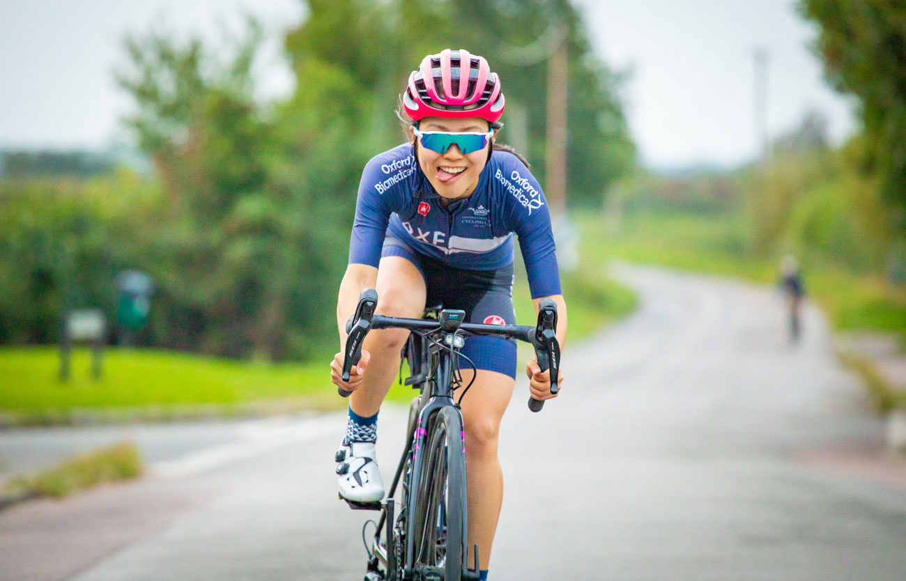 Student cyclist riding wearing OU Cycling Club kit