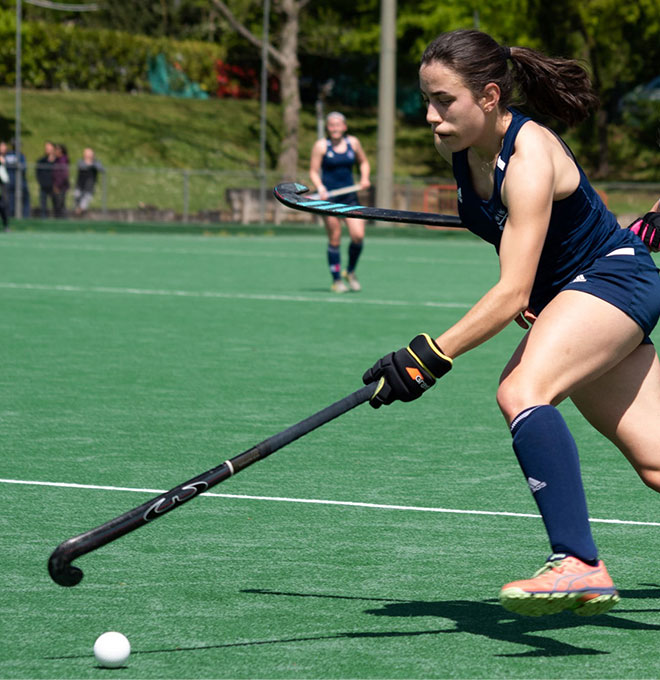 OUHC Women’s Blues team playing at the 2021 Varsity match. Photo Credit: Erin Forsyth