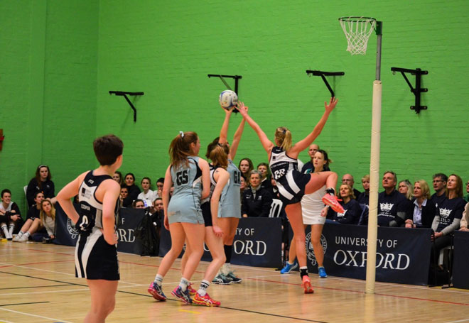 Netball player blocking shot during game