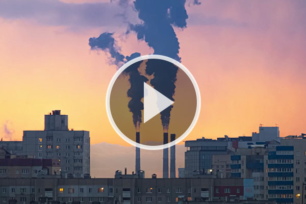 Cityscape showing power station smoking chimneys